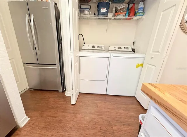 a view of a kitchen with a sink and refrigerator