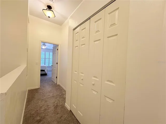 a view of a hallway with wooden shelves