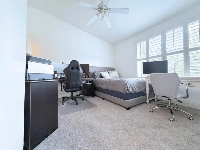 a bedroom with a bed and a chair