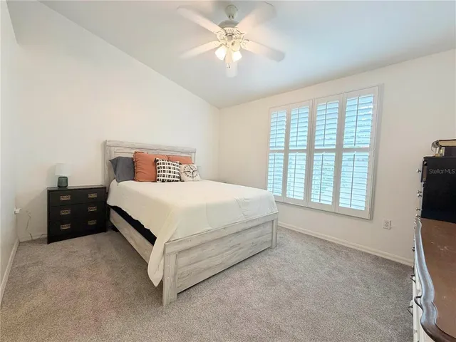 a bedroom with a bed and a tv