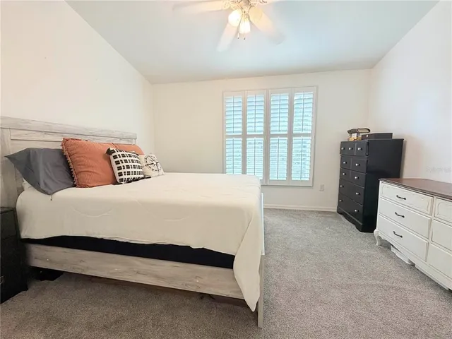 a spacious bedroom with a bed and a window