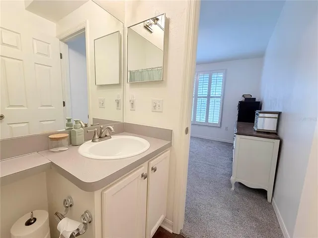 a en suite bathroom with a sink double vanity and a mirror