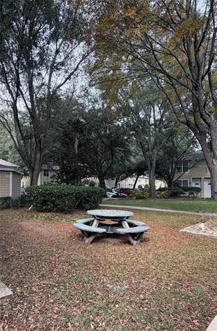 a backyard of a house with trees and entertaining space