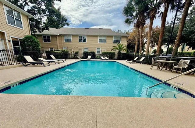 a view of a house with swimming pool and sitting area