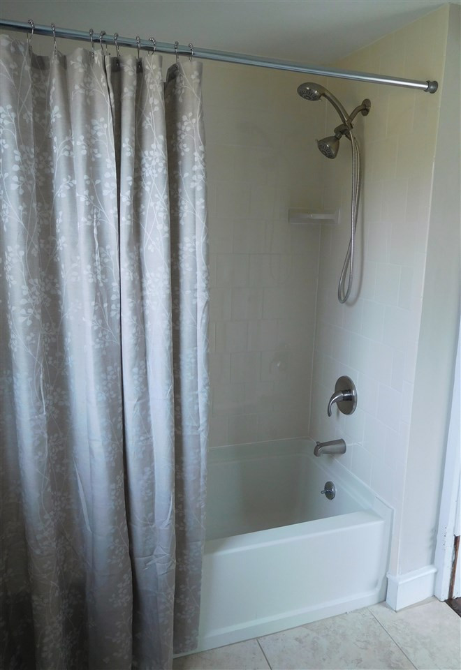 1770 Cooper Branch Road Clayton, NC 27520 - Photo 19 of 24 New ceramic tile surrounding bath-tub to ceiling, double shower head. Master Bath/Spa