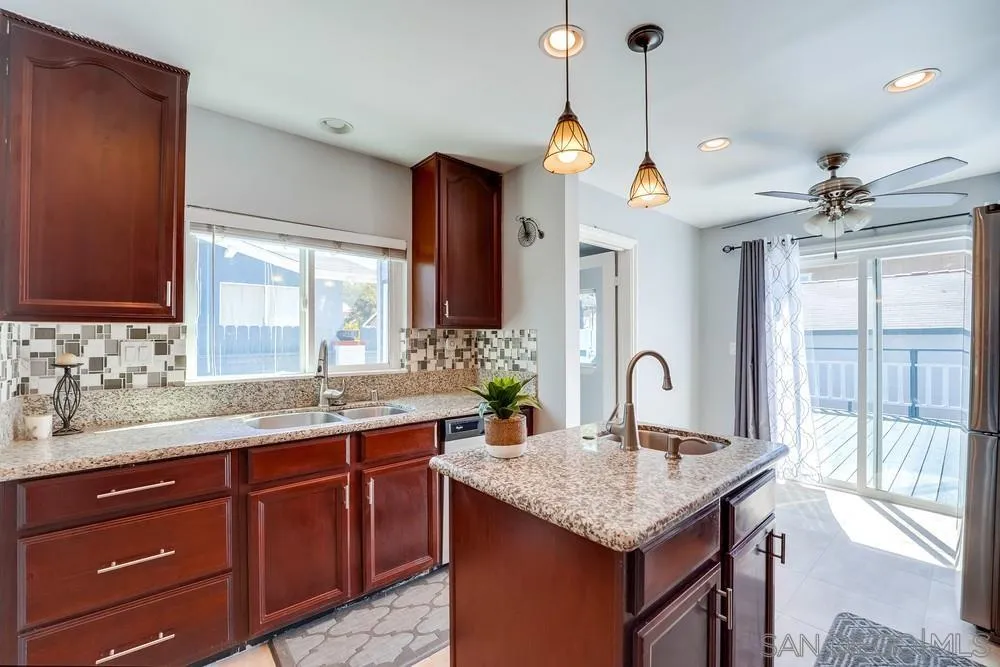 9055 Rosedale Drive Spring Valley, CA 91977 - Photo 11 of 38 a kitchen with a counter space a sink and chandelier
