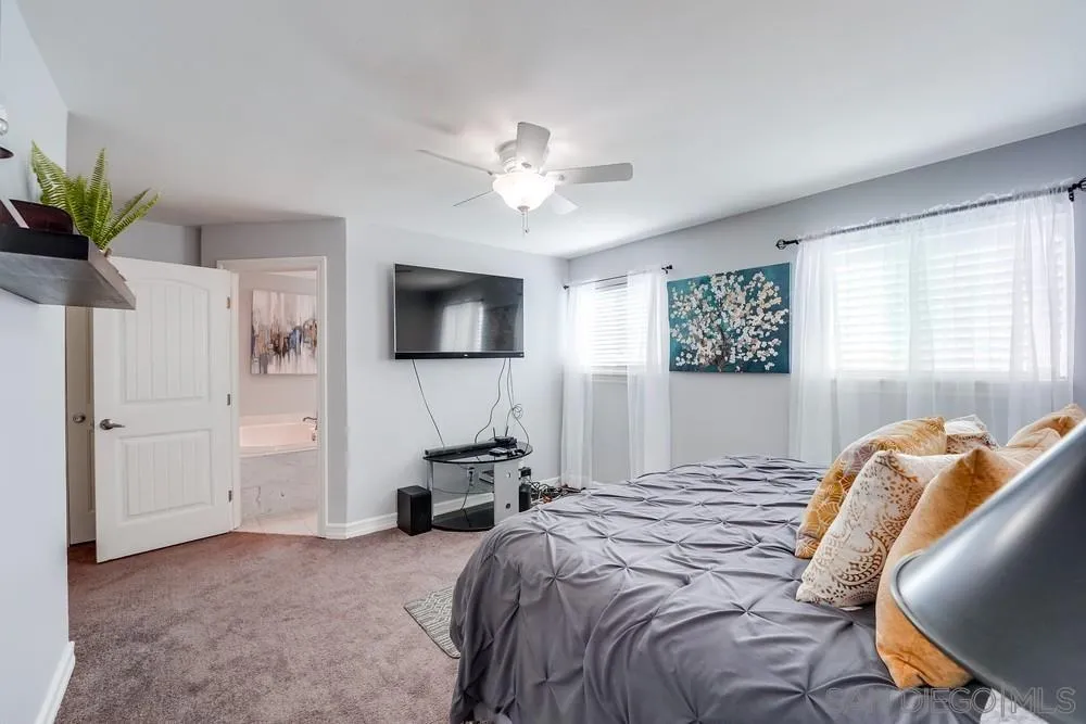 9055 Rosedale Drive Spring Valley, CA 91977 - Photo 21 of 38 a bedroom with a bed and a chandelier