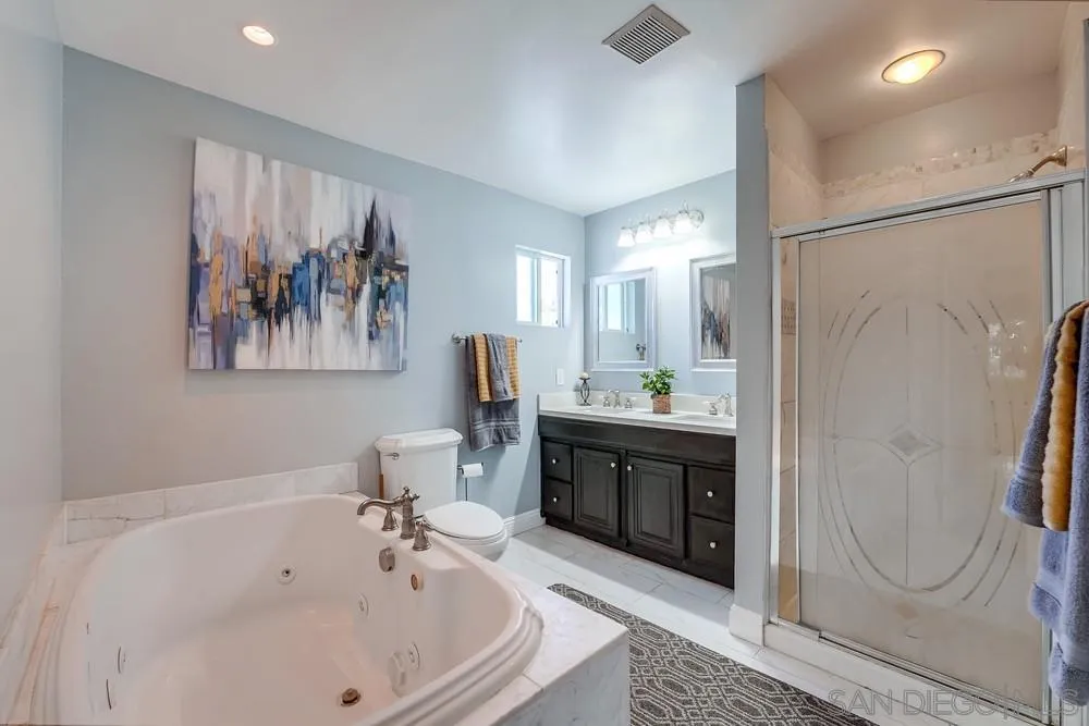 9055 Rosedale Drive Spring Valley, CA 91977 - Photo 22 of 38 a white bath tub sitting next to a bathroom