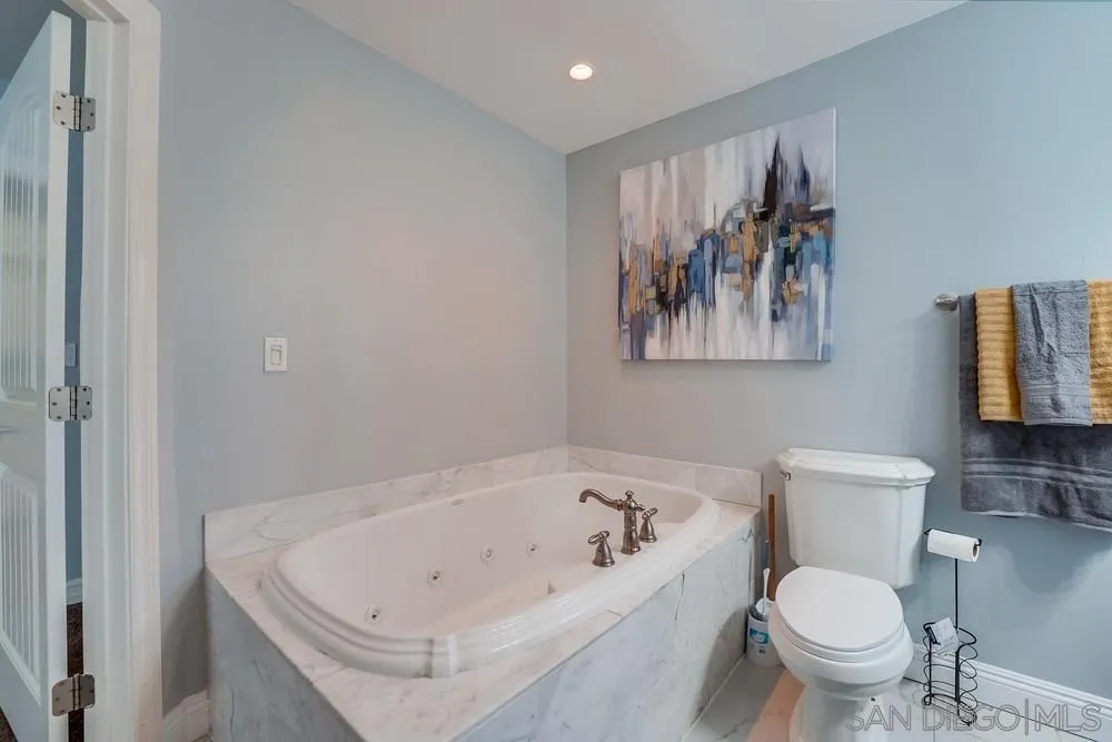 9055 Rosedale Drive Spring Valley, CA 91977 - Photo 23 of 38 a white bath tub sitting next to a toilet