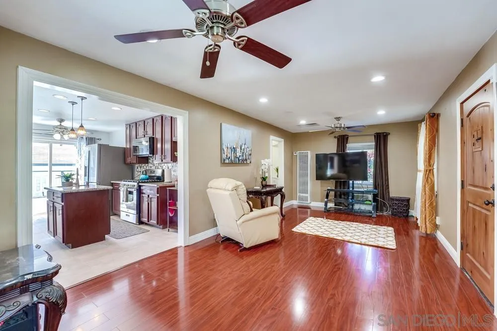 9055 Rosedale Drive Spring Valley, CA 91977 - Photo 7 of 38 a living room with furniture a flat screen tv and wooden floor