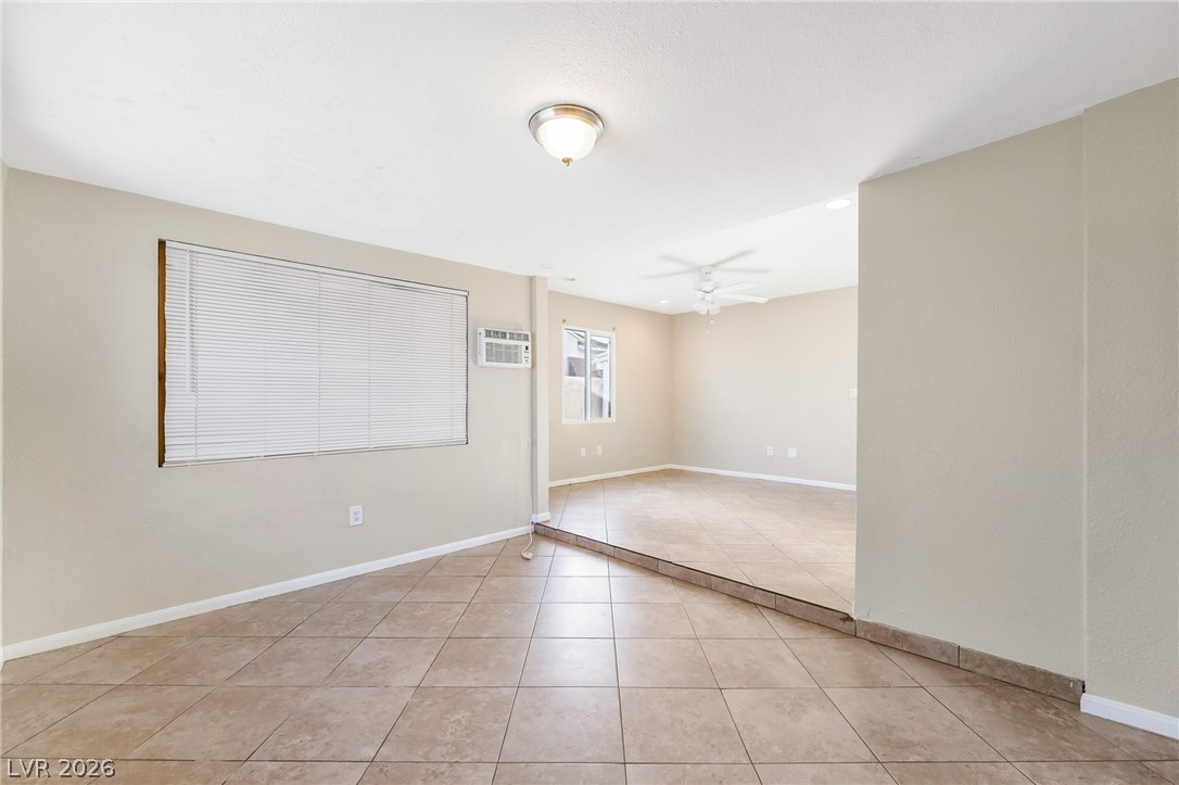 140 West Victory Road Henderson, NV 89015 - Photo 5 of 24 Step into this spacious room featuring versatile tiled flooring and ample natural light.