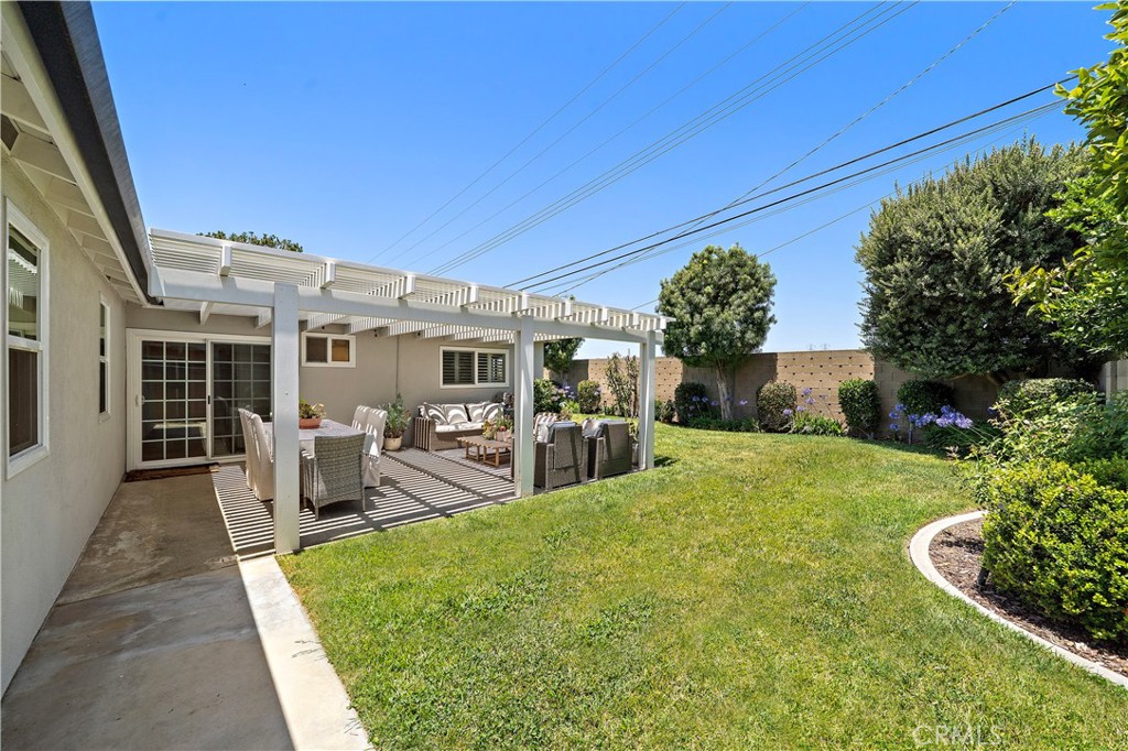 8741 La Roca Avenue Fountain Valley, CA 92708 - Photo 36 of 50 Covered patio, lush lawn, and beautiful gardens