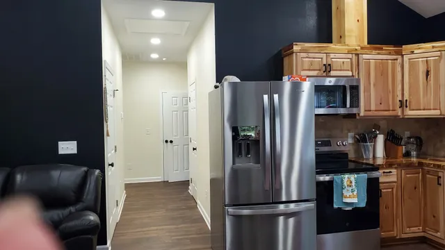 a kitchen with stainless steel appliances granite countertop a refrigerator and a stove