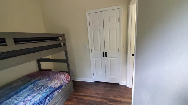 a en suite bathroom with a granite countertop sink and a mirror