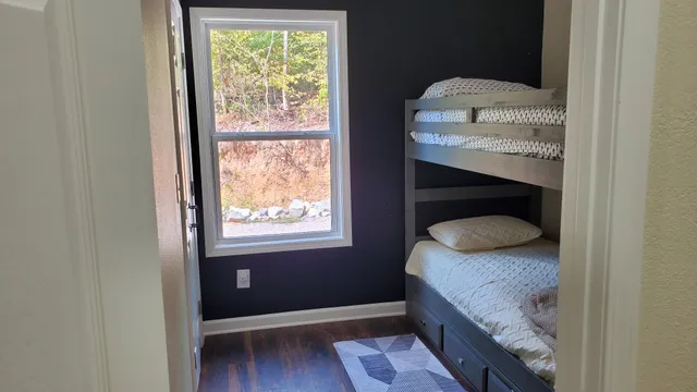 a bedroom with a bed and a window