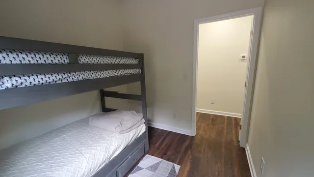 a white toilet sitting next to a sink and vanity