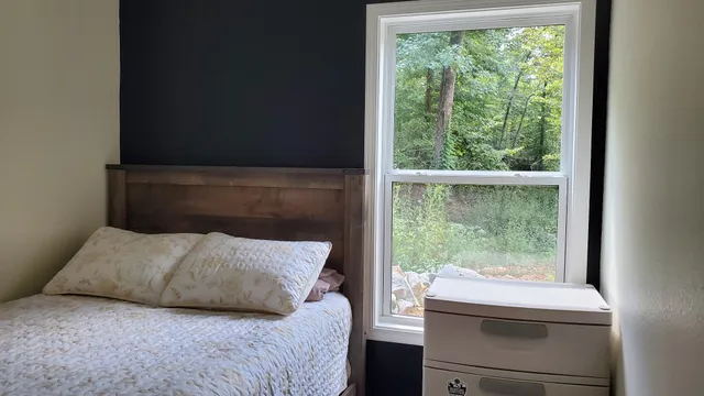 a bedroom with a bed and a window