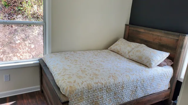 a bedroom with a bed and window