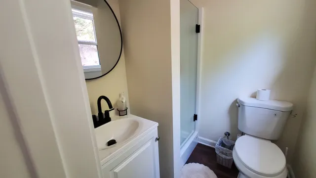 a view of a livingroom with wooden floor and furniture