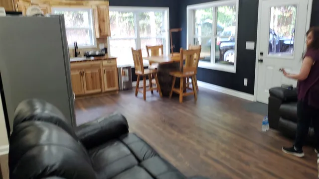 a living room with furniture and wooden floor