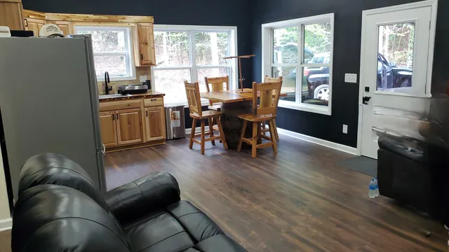a living room with furniture and large windows