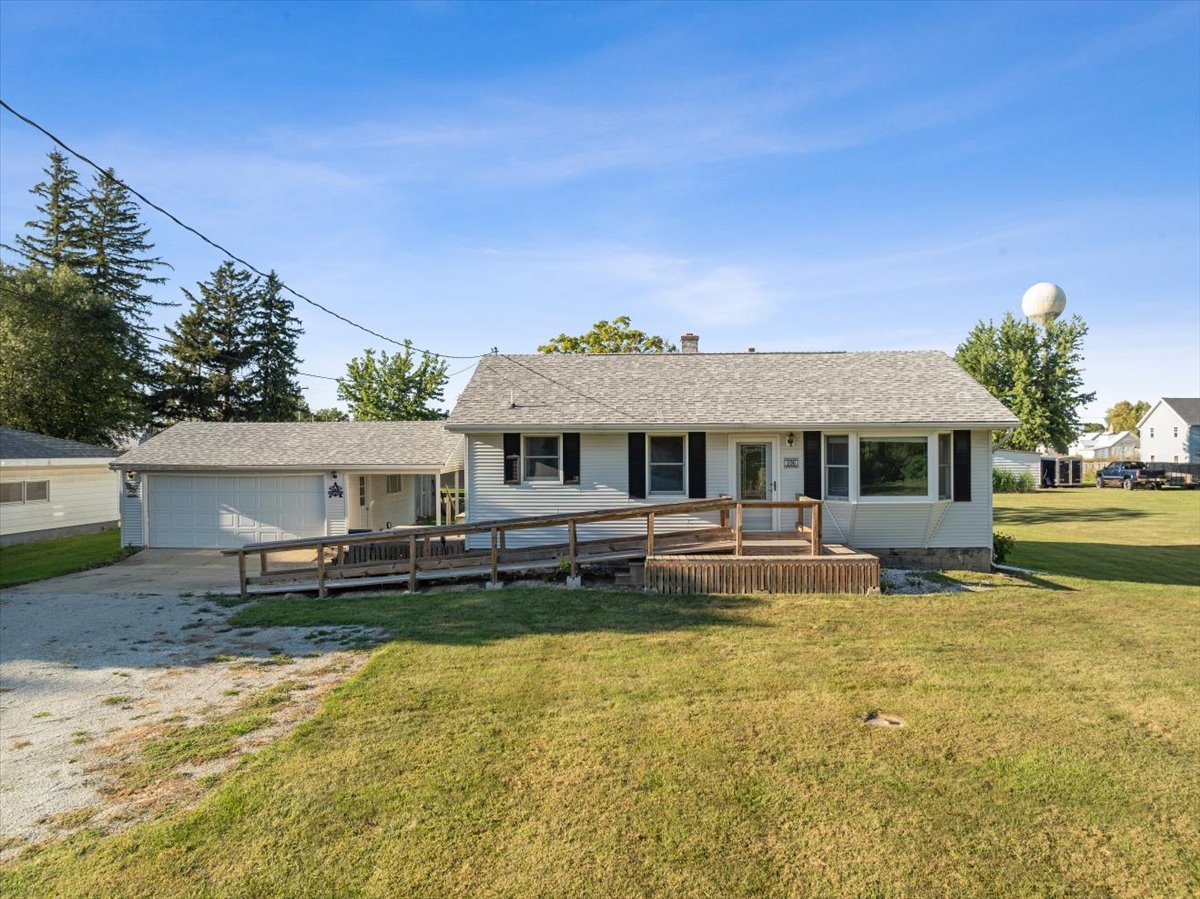 a front view of a house with a yard table and chairs