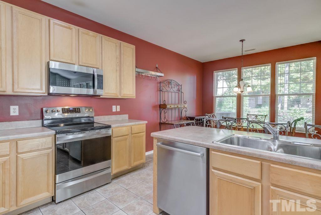 8306 Flat Keystone Drive Raleigh, NC 27613 - Photo 13 of 30 a kitchen with sink stove and cabinets