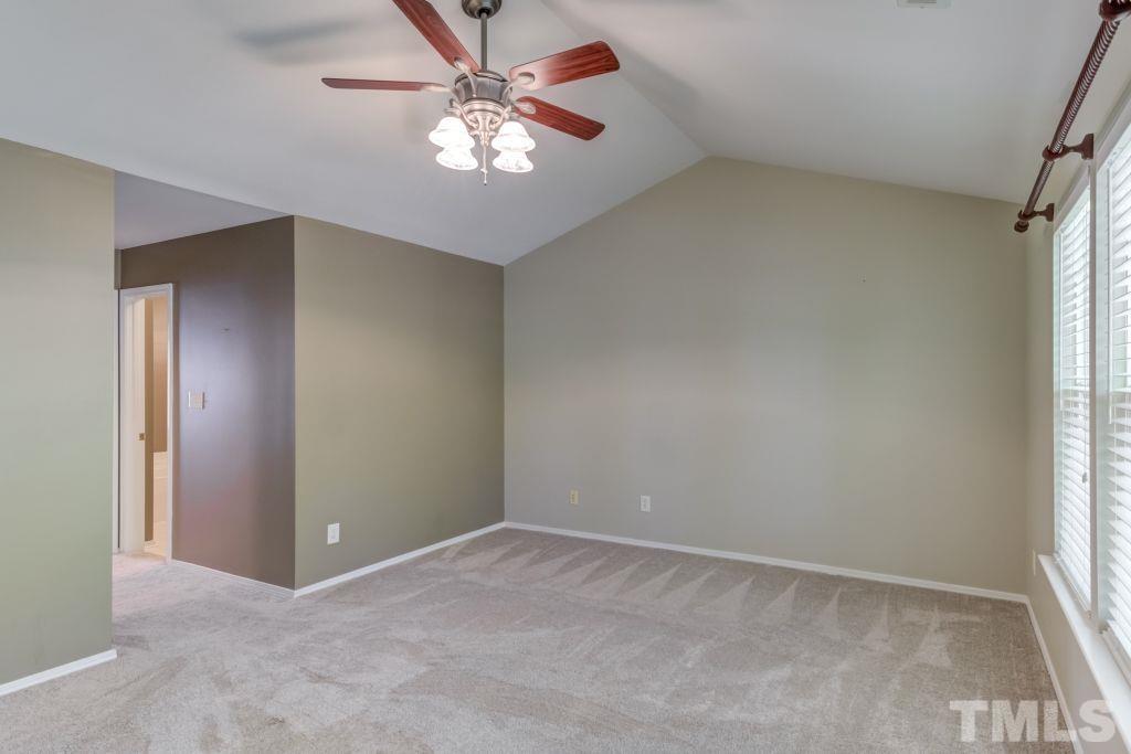 8306 Flat Keystone Drive Raleigh, NC 27613 - Photo 18 of 30 an empty room with windows and fan