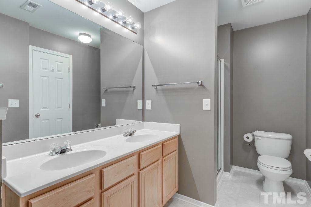 8306 Flat Keystone Drive Raleigh, NC 27613 - Photo 21 of 30 a bathroom with a sink a toilet and a mirror