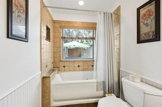 a bathroom with a bathtub and a shower