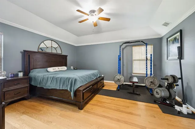 a bed sitting in a room next to a lamp