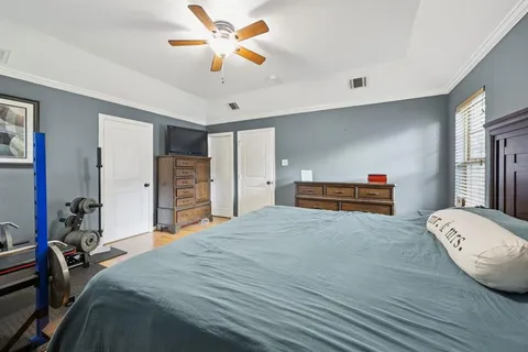 a bed room with a bed and a chandelier