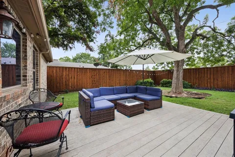a backyard of a house with table and chairs