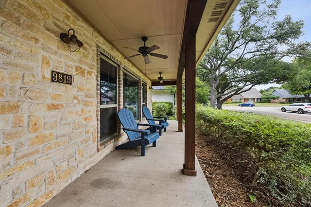 a view of a patio with table and chairs with wooden floor and fence