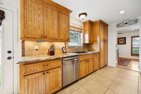 a kitchen with stainless steel appliances granite countertop a sink and cabinets