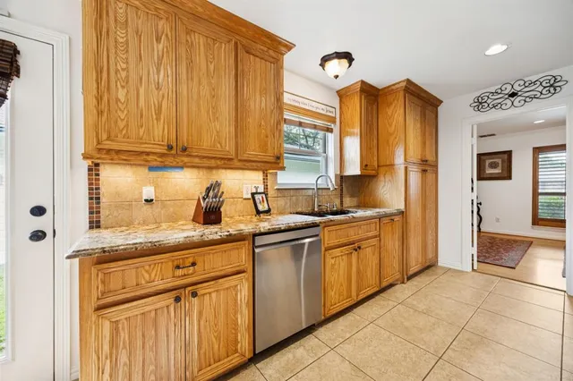 a kitchen with stainless steel appliances granite countertop a sink and cabinets