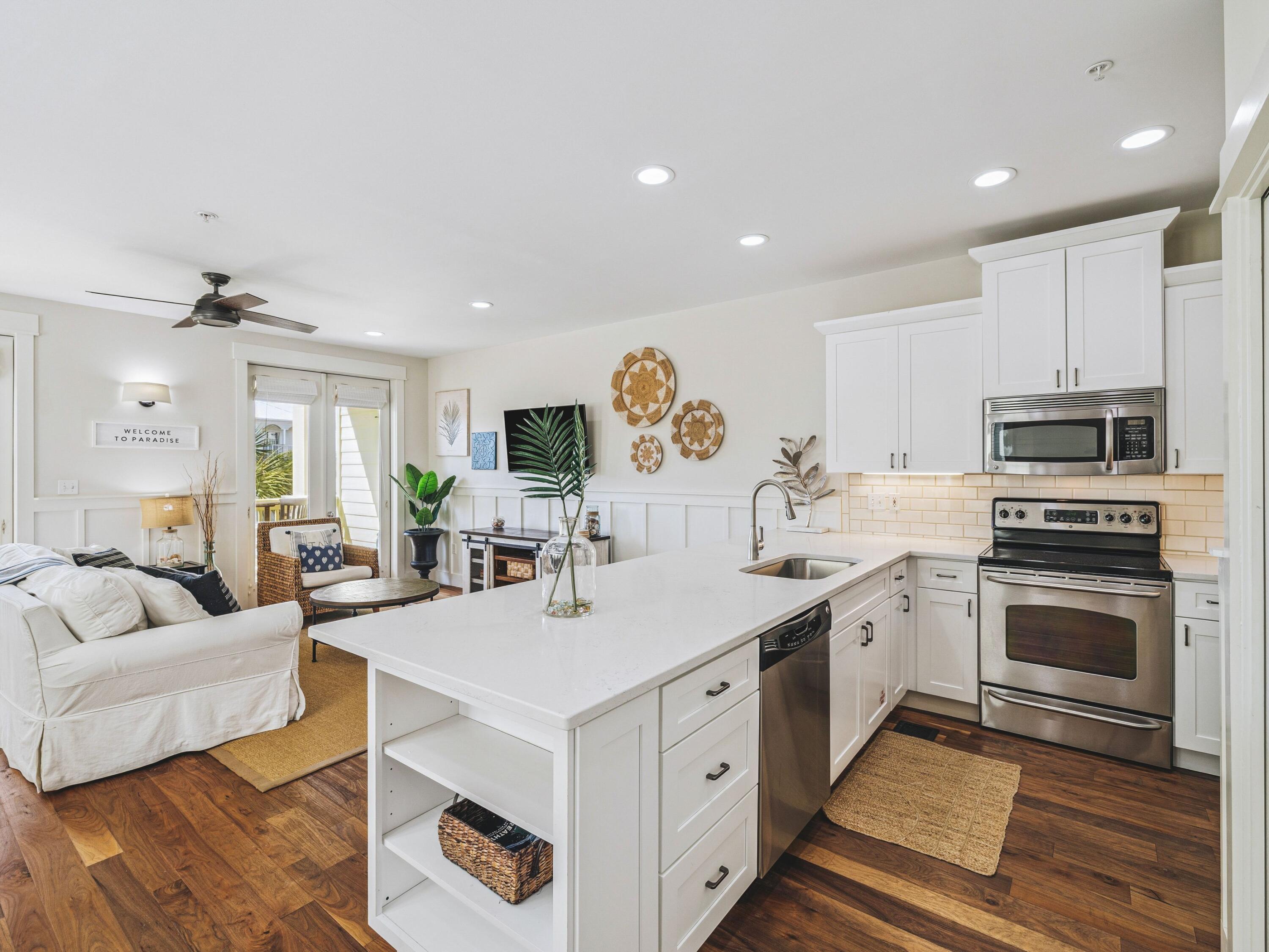 4281 East County Highway 30A, Unit 203 Santa Rosa Beach, FL 32459 - Photo 2 of 35 a view of kitchen with center island wooden floor and living room view