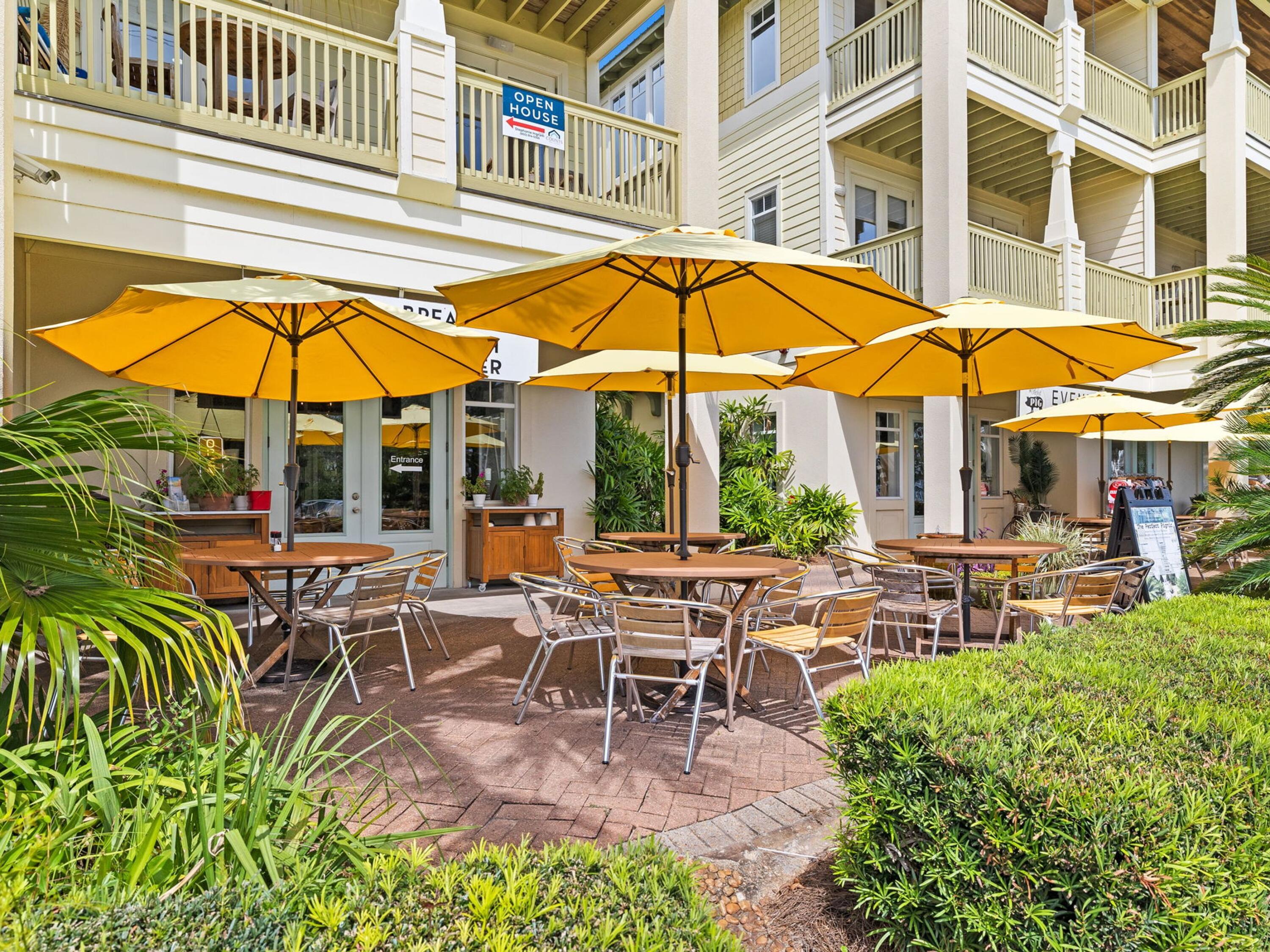 4281 East County Highway 30A, Unit 203 Santa Rosa Beach, FL 32459 - Photo 33 of 35 a view of a swimming pool with a table and chairs under an umbrella