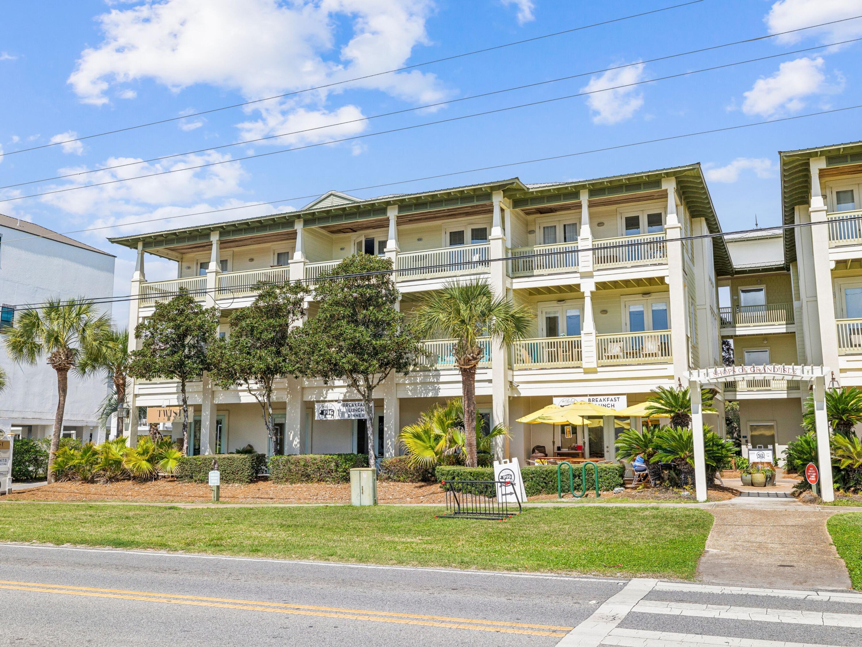 4281 East County Highway 30A, Unit 203 Santa Rosa Beach, FL 32459 - Photo 6 of 35 a front view of a building with a garden and plants