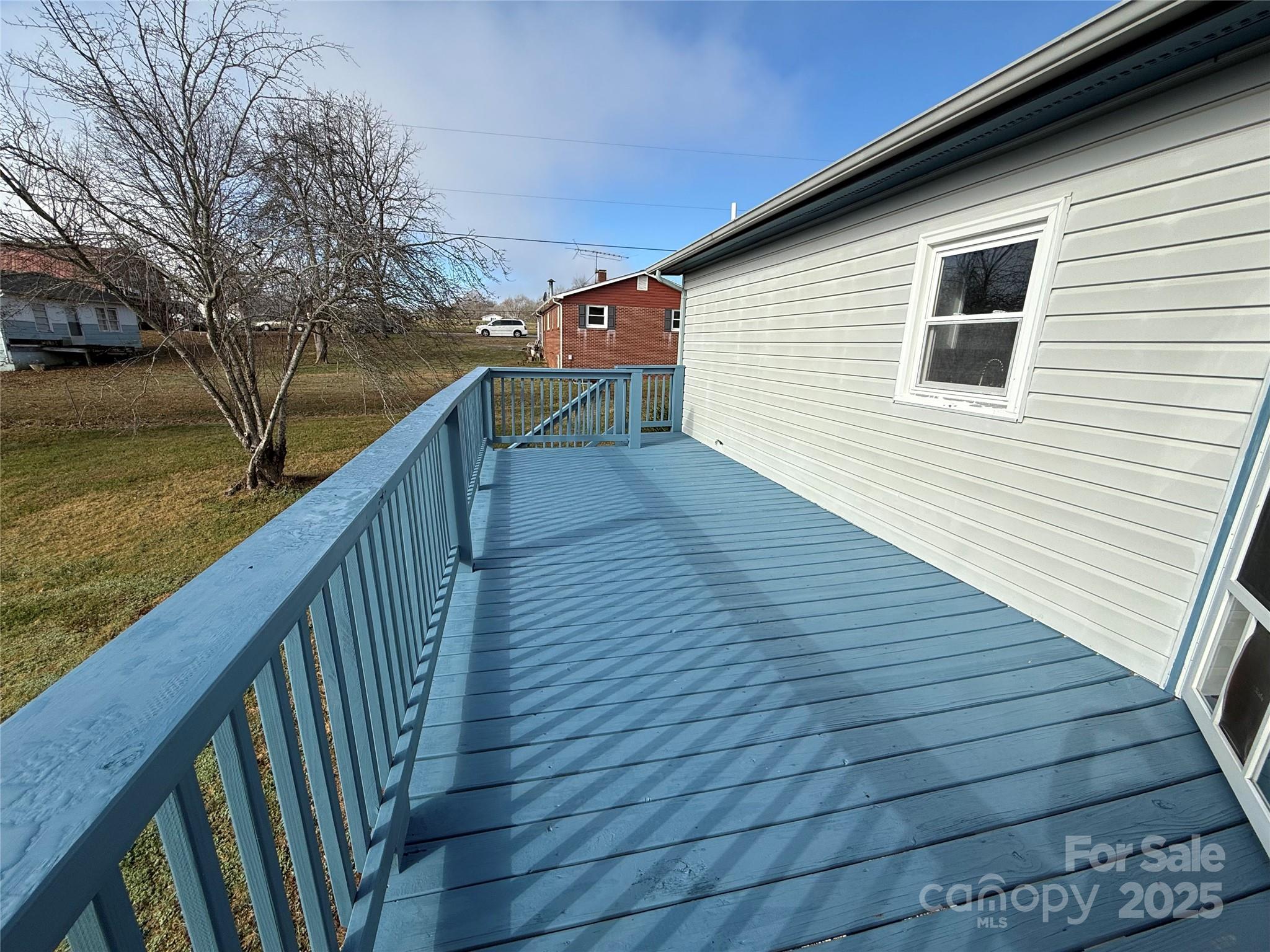 4554 Horseshoe Bend Road Hudson, NC 28638 - Photo 6 of 21 a balcony with wooden floor and trees