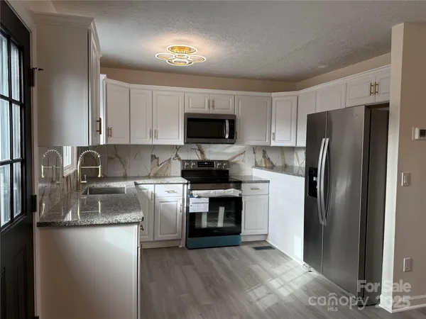 a kitchen with a refrigerator sink and stove