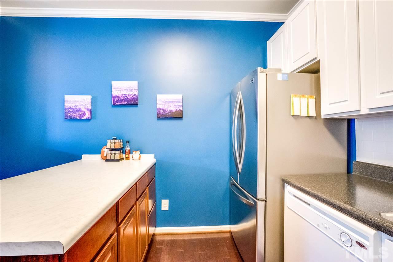 11710 Coppergate Drive, Unit 105 Raleigh, NC 27614 - Photo 11 of 24 a room with cabinets and a wooden floor
