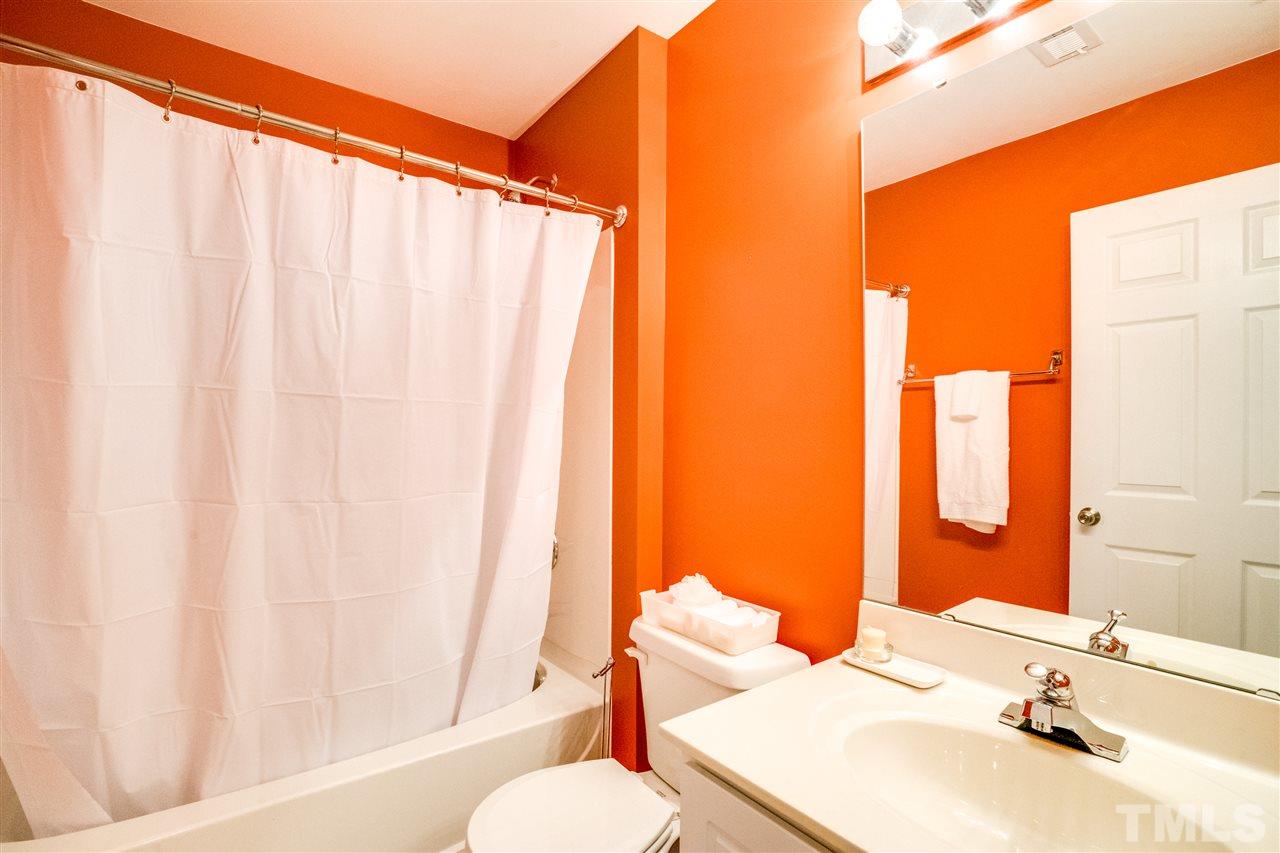 11710 Coppergate Drive, Unit 105 Raleigh, NC 27614 - Photo 14 of 24 a bathroom with a sink and a mirror