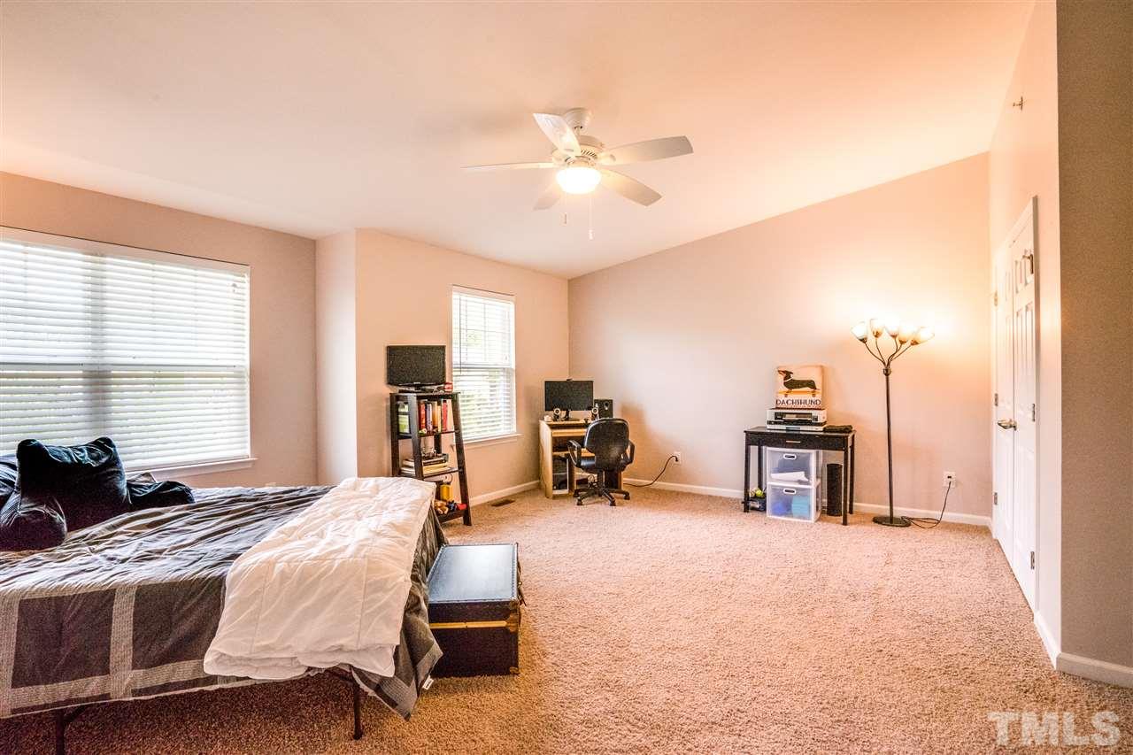 11710 Coppergate Drive, Unit 105 Raleigh, NC 27614 - Photo 17 of 24 a bedroom with furniture and a large window