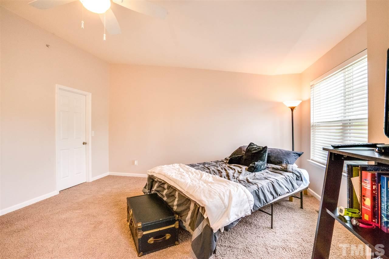 11710 Coppergate Drive, Unit 105 Raleigh, NC 27614 - Photo 19 of 24 a bedroom with a bed and wooden floor