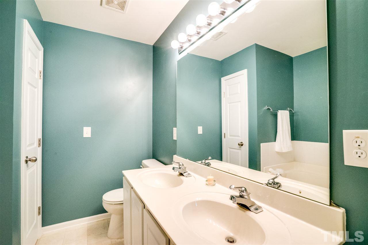 11710 Coppergate Drive, Unit 105 Raleigh, NC 27614 - Photo 21 of 24 a bathroom with a sink and a mirror