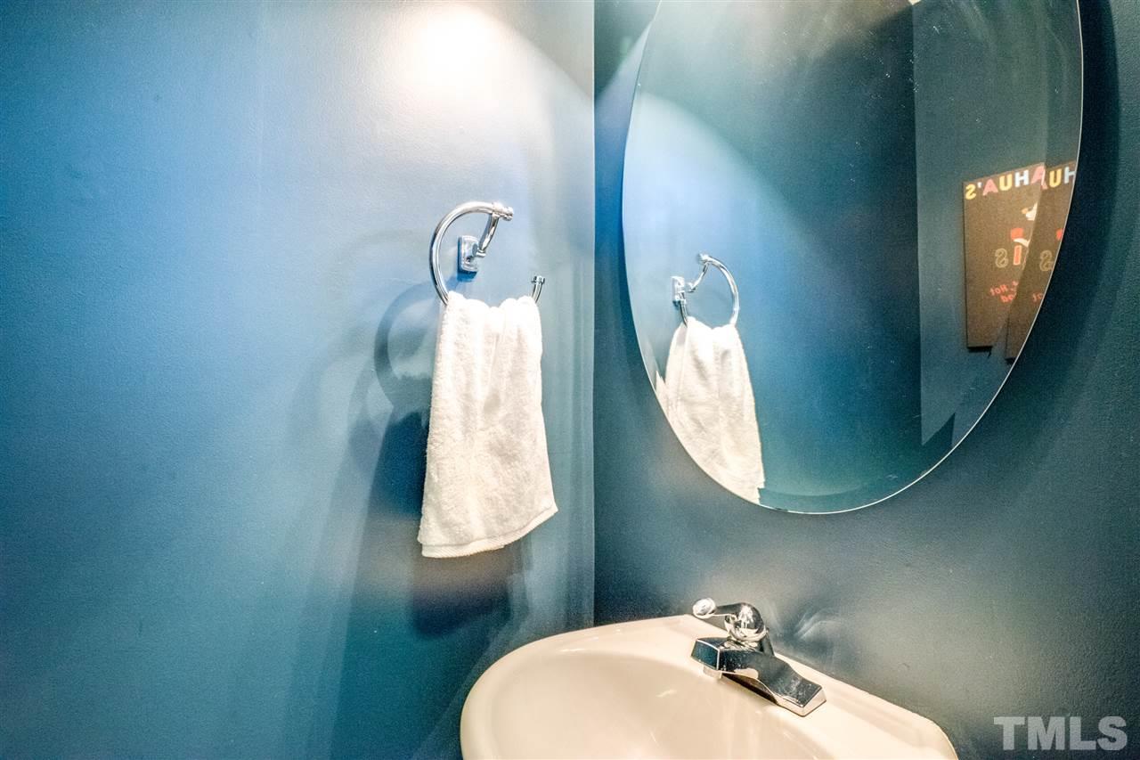 11710 Coppergate Drive, Unit 105 Raleigh, NC 27614 - Photo 5 of 24 a bathroom with a mirror and a sink