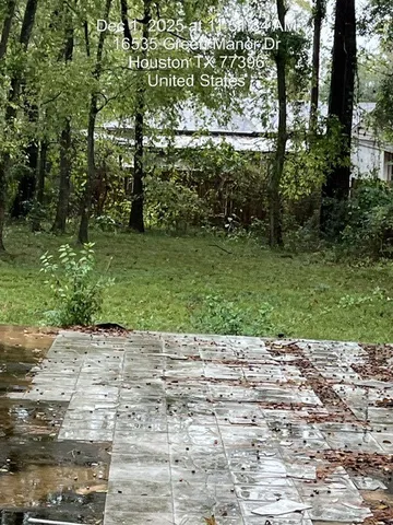 a view of a backyard with sitting area