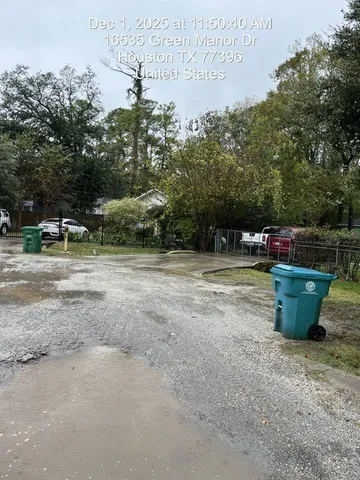 a view of a street with large trees