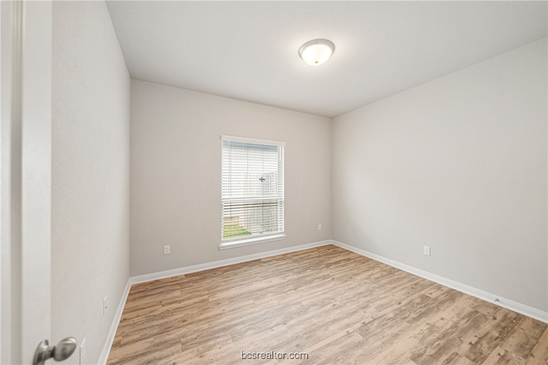 2018 Brisbane Way Bryan, TX 77807 - Photo 15 of 39 an empty room with wooden floor and windows